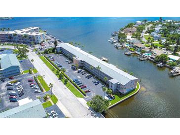 Aerial view of waterfront condo building with parking and boat slips at 1893 Shore S Dr # 206, South Pasadena, FL 33707