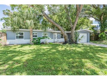 Charming single-story home with a lush lawn and mature trees at 345 Country Club Dr, Oldsmar, FL 34677