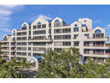 Three-story building with balconies and lush landscaping at 2333 Feather Sound Dr # A203, Clearwater, FL 33762