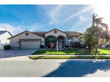 One-story home with a two-car garage and landscaped yard at 12528 Roseland Dr, New Port Richey, FL 34654