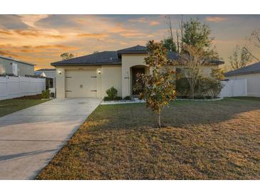 One-story home with attached garage and landscaped yard at 26416 Mcallister St, Brooksville, FL 34602
