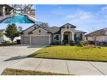 House exterior featuring a three-car garage and well-manicured lawn at 692 Challice Dr, Spring Hill, FL 34609