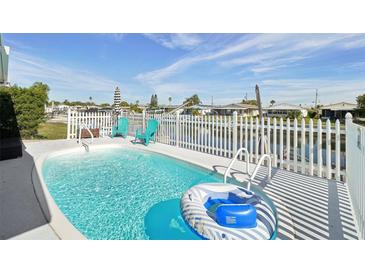 Inviting refreshing pool with a floating raft, perfect for relaxation at 5102 Blue Heron Dr, New Port Richey, FL 34652