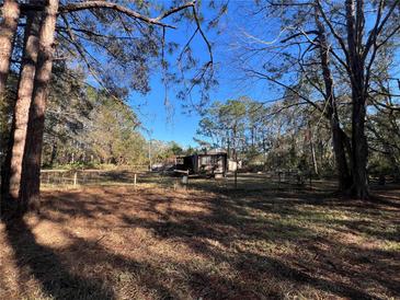 Mobile home on wooded lot with fenced yard at 10926 Webb St, New Port Richey, FL 34654