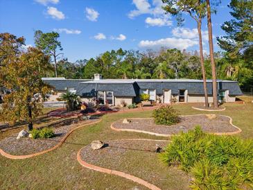 Single-story home with a large yard and mature trees at 7815 Tanglewood Dr, New Port Richey, FL 34654