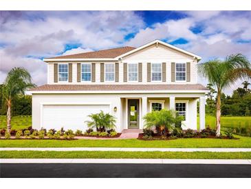 Two-story house with a white exterior, brown roof, and landscaping at 10017 Zennia Ln, Parrish, FL 34219