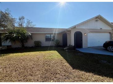 Single story home with attached garage and spacious yard at 13008 Fish Cove Dr, Spring Hill, FL 34609