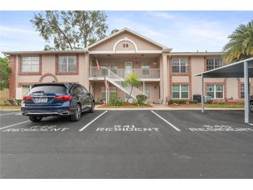 Two-story condo building with parking and landscaping at 6604 Spring Flower Dr # 23, New Port Richey, FL 34653
