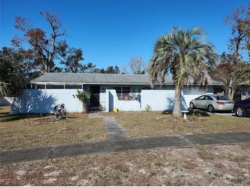 Ranch style home with carport and mature landscaping at 4230 Lee Rd, Spring Hill, FL 34608