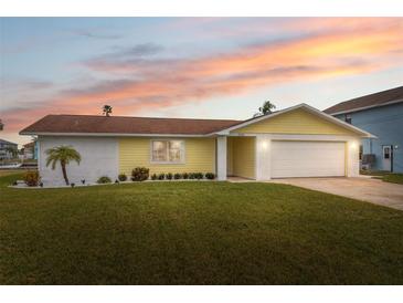 Updated single story home with a landscaped lawn and attached garage at 4270 Paradise Cir, Hernando Beach, FL 34607