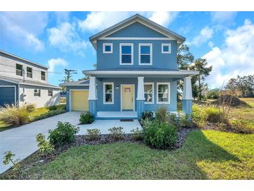 Newly built home featuring a yellow door and blue exterior at 5742 Meadowlane St, New Port Richey, FL 34652