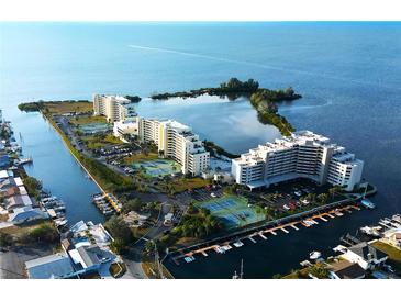 Aerial view of waterfront community with tennis courts and marina at 5915 Sea Ranch Dr # 704, Hudson, FL 34667