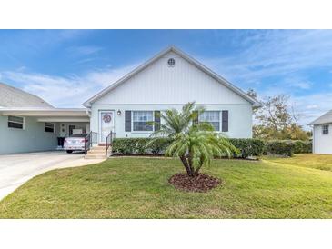 Charming light green single-story home with a well-manicured lawn at 6650 Hickorywood Ln # 6650, New Port Richey, FL 34653