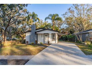 Newly renovated home with a modern exterior and landscaped front yard at 405 Pine S Ave, Oldsmar, FL 34677