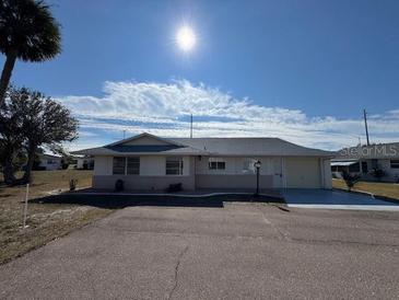 Single-story home with attached garage, driveway, and mature landscaping at 705 Churchill Pl, Sun City Center, FL 33573