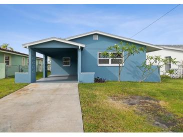 Newly renovated light blue house with carport and small front yard at 4430 Floramar Ter, New Port Richey, FL 34652