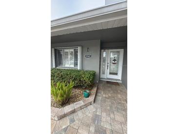 Inviting front entrance with landscaped walkway and updated door at 5341 Windward Way, New Port Richey, FL 34652