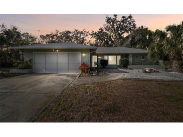 One-story house with attached garage, landscaping, and a paved driveway at 8446 Braganza St, Spring Hill, FL 34608