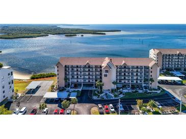 Aerial view of waterfront condo building with parking and water access at 4620 Bay Blvd # 1145, Port Richey, FL 34668