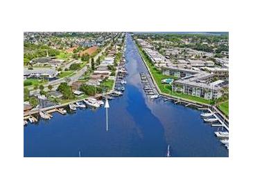 Aerial view showing waterfront property with boat slips and canal access at 4907 Floramar Ter, New Port Richey, FL 34652