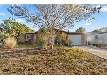 Brick ranch home with a large front yard and mature trees at 4130 Ridgefield Ave, Holiday, FL 34691