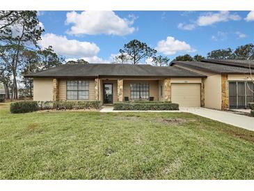 Cute one-story home with stone accents and a two-car garage at 7267 Prince George Ct, Spring Hill, FL 34606