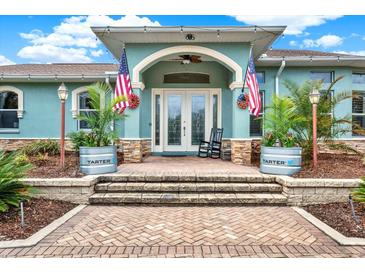 Inviting home exterior with double doors and a brick walkway at 10030 Orchard Way, Spring Hill, FL 34608