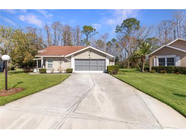 Cute Florida home with carport and well-manicured lawn at 11830 Wax Myrtle Ct, New Port Richey, FL 34654