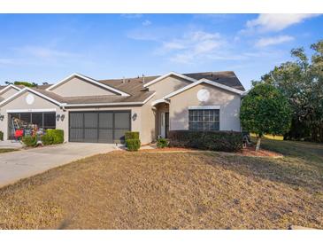 Cute two-bedroom villa with a screened-in porch and attached garage at 410 Candlestone Ct, Spring Hill, FL 34609