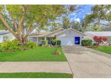 Attractive single-story home with a well-manicured lawn and driveway at 4710 Parkdale Ln, New Port Richey, FL 34655