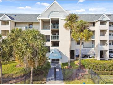 Heather Cove II building exterior, featuring a gated entrance and palm trees at 5557 Sea Forest Dr # 117, New Port Richey, FL 34652