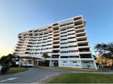 Stunning view of the white condominium building exterior against a clear, blue sky on a sunny day at 30 Turner St # 208, Clearwater, FL 33756