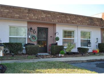 Well-maintained condo building with attractive landscaping and individual unit entrances at 6124 Chesham Dr # 6, New Port Richey, FL 34653