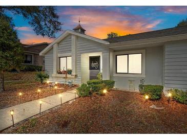 Charming home exterior featuring landscaped yard, walkway lights, and unique architectural details at 8194 Sturbridge Ct # A, Weeki Wachee, FL 34613