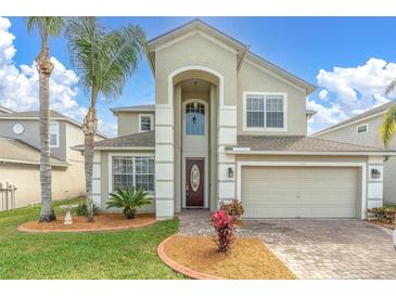 Two-story home featuring a well-manicured lawn, tall arched entry, and attached two car garage at 1442 Lenton Rose Ct, Trinity, FL 34655