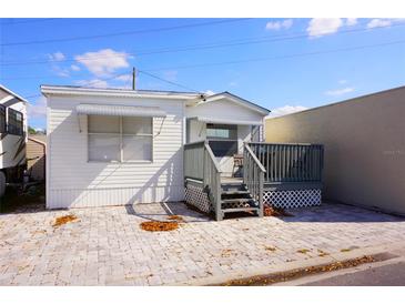 Charming single-story home with a front porch and paved patio area at 21131 Lazy Days Circle, Lutz, FL 33558