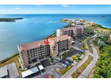 Beautiful waterfront condominium building with lush landscaping, ample parking, and serene ocean views at 4620 Bay Blvd # 1154, Port Richey, FL 34668