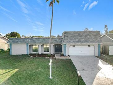 Charming single-story home featuring an attached garage and well-manicured lawn at 3640 Richboro Dr, Holiday, FL 34691