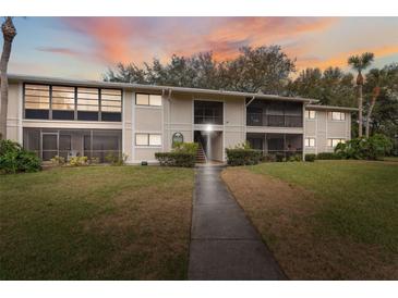 Inviting exterior view of the condo building with well-maintained lawn and landscaping at 6002 Laketree Ln # L, Temple Terrace, FL 33617