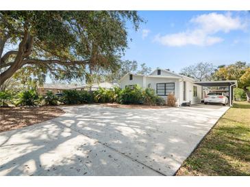 Charming single-story home with a spacious driveway and well-maintained landscaping at 6305 S Macdill Ave, Tampa, FL 33611