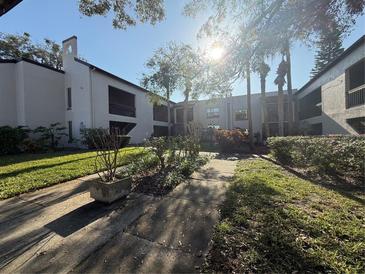 Condominium exterior with a well-maintained lawn and landscaping, enhancing its curb appeal at 2971 Estancia Blvd # 310, Clearwater, FL 33761