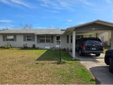 Charming single-story home with covered carport and well-maintained front yard at 5900 Beech St, Zephyrhills, FL 33542
