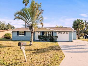 Charming single-story home with mature landscaping and a two-car garage at 7200 Palisade Dr, Port Richey, FL 34668