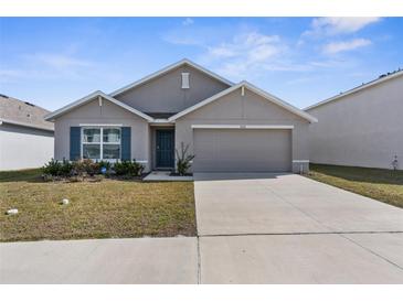 Charming single-story home with a well-manicured lawn, attached two-car garage, and neutral paint at 7552 Gardner St, Brooksville, FL 34613