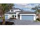 Two-story home with light-colored walls, gray roof, and a two-car garage at 1625 Hansen St, Sarasota, FL 34231