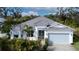 Beautiful home with gray roof and light blue garage at 3934 Sunshine Ave, Sarasota, FL 34231