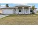 Charming home showcasing an expansive front lawn and an attached two-car garage at 2781 Shady Ave, North Port, FL 34286