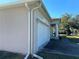 Attached garage featuring white door and clean white gutters, offering convenience and storage at 2781 Shady Ave, North Port, FL 34286