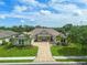 Luxury home with tile roof, landscaping and paved driveway at 11826 River Shores Trl, Parrish, FL 34219