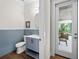Stylish powder room with blue tile and access to outdoor space at 11826 River Shores Trl, Parrish, FL 34219